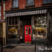 One of three haunted taverns of Sleepy Hollow Country, Set Back Inn in Tarrytown, NY has a red door between two plate glass windows.